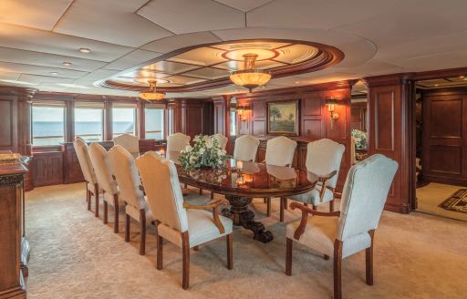 Charter yacht NOMAD interior dining area with long table