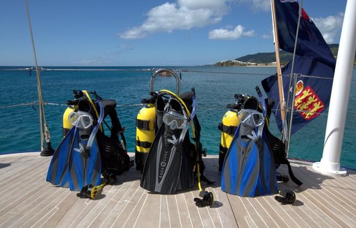 scuba diving equipment lines up on swim platform of luxury yacht PTARMIGAN 