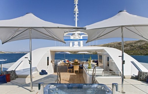 awning shade the Jacuzzi and bar and dining lies beyond on sundeck of luxury yacht Mary-Jean II 