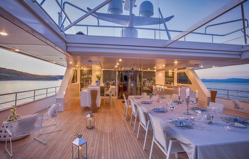 Charter yacht KATINA alfresco dining area with long table and white chairs