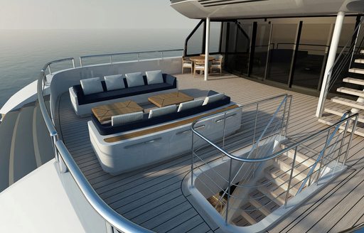 exterior decks of soaring yacht, with sofa seating and steps leading to aft decks