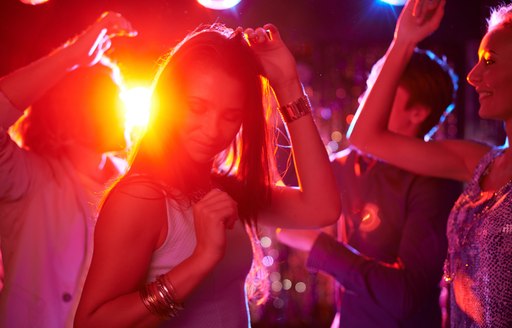 people dancing at a party on board a superyacht 