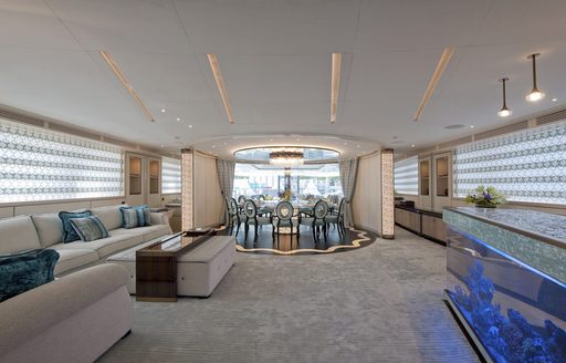 Interior dining set up onboard boat charter SCORPION with a lounge area in the foreground