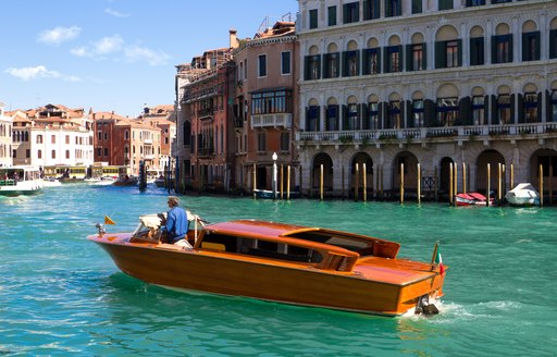 A small boat cruising along Venice canal
