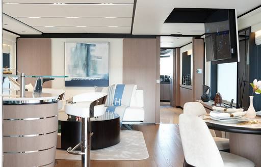 Interiors with wet bar and seating area onboard charter yacht GEULUNEL
