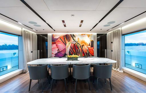 Charter yacht OURANOS interior dining area with large windows