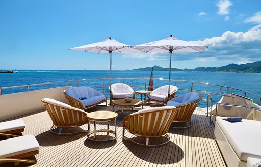 Shaded seats and table on deck on superyacht LIONSHARE