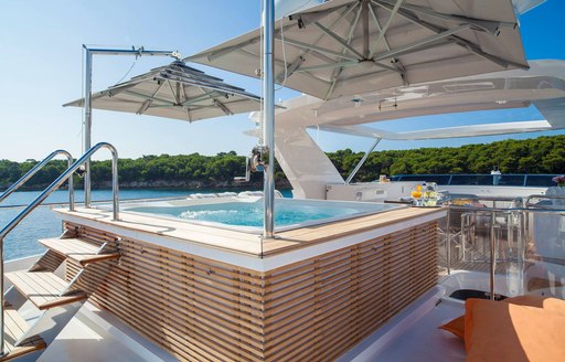 spa pool with umbrellas overhead on the sundeck of luxury yacht DYNAR