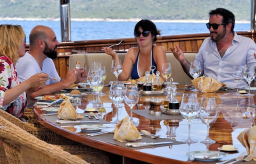 Charter guests enjoy a meal on Christina O