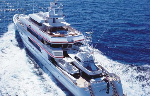 Aerial running shot of charter yacht NOMAD, with a sports fisher yacht on the aft deck