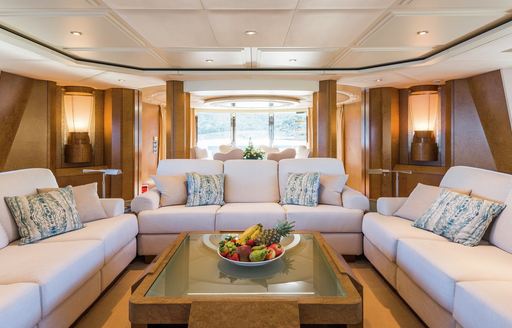 Main salon lounge area with plush cream sofas onboard boat charter BENITA BLUE