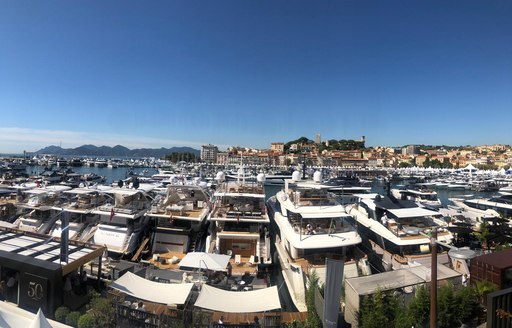 Aft decks of yachts lined up at cannes yachting festival