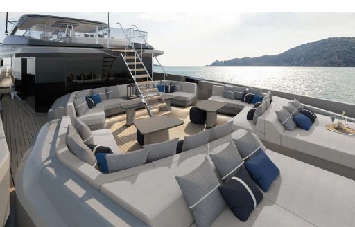 Exterior seating area onboard yacht charter AKULA with sun pads in the foreground