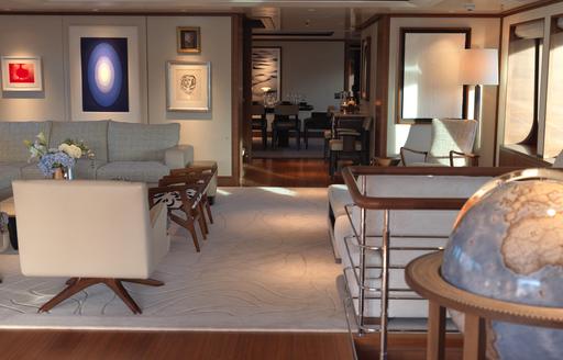 Charter yacht SOLACE interiors with lounge area and globe
