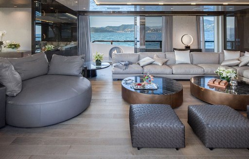 Interior styling and main salon of M/Y A, with sofa seating and coffee tables