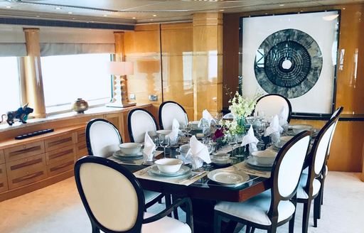 Formal dining area with long table dressed for a meal onboard charter yacht LADY AZUL