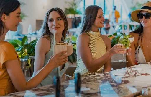 SĀN Beach charter guests toasting drinks