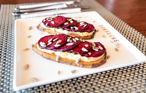 Toasted beet served on rectangular white plate
