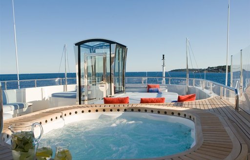 Spa pool of charter yacht LATITUDE, with elevator in background and sunpads