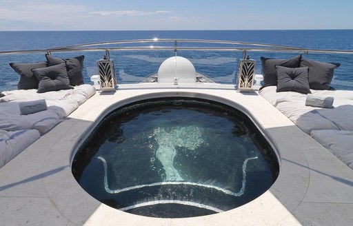 mosaic-lined swimming pool surrounded by sand-blasted travertino on sundeck of motor yacht Silver Angel 