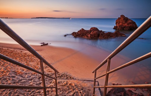 Beaches of the French Riviera: staircase descending on the beach at sunrise - Cannes