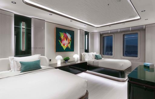 Overview of a guest cabin onboard charter yacht MALIA with a single and double berth plus two large windows