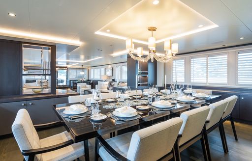 Interior dining table and surrounding chairs onboard superyacht charter EMERALD