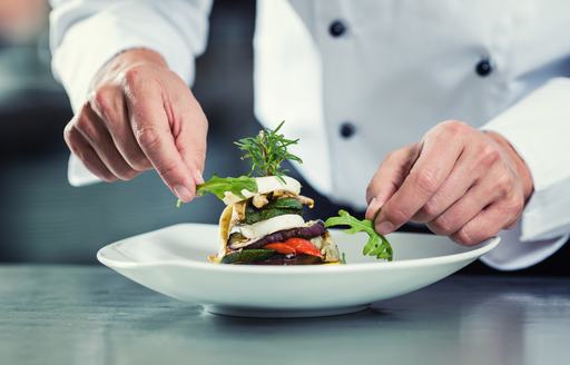 Close up of chef putting final touches to a dish