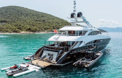 Charter yacht BLISS at anchor with her water toys adjacent