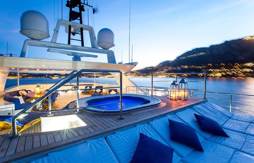 jacuzzi and sun pads as sun sets on board luxury yacht MISCHIEF