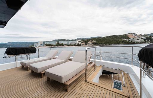 Charter yacht BEYOND CAPRICORN line of sun loungers