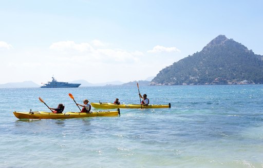 kayaking in the mediterranean, with amels yacht spirit in background