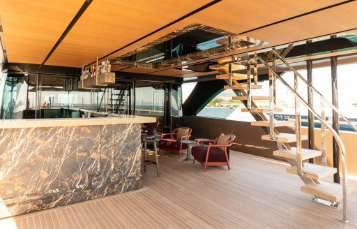 Exterior deck space with a wet bar onboard charter yacht RAJA²