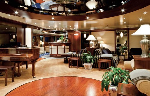 Main salon aboard superyacht Lauren L, with piano