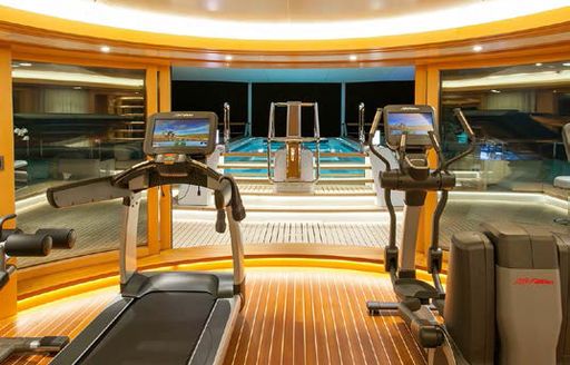 Gym equipment and blue pool on luxury yacht SOLANDGE