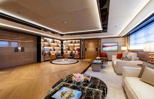 Upper salon with armchairs and large window onboard charter yacht PROJECT X