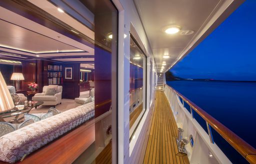 Charter yacht TELEOST exterior walkway at nightfall