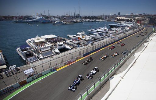 formula 1 cars race in front of luxury yachts in Monaco 