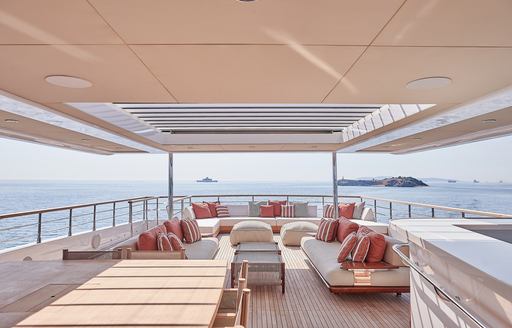 Charter yacht ONE ZERO exteriors with shaded seating and a wet bar