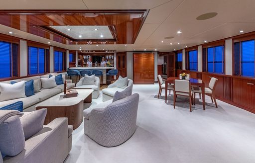 Charter yacht PISCES upper salon and lounge area to port