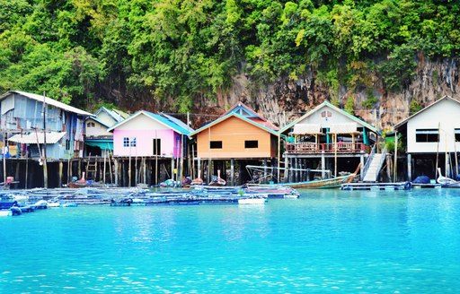 houses on stilts in a fishing village in Thailand waters