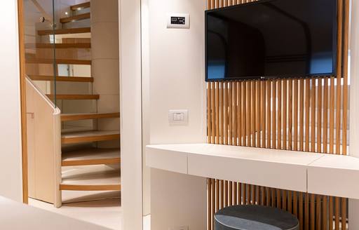 Charter yacht PH2 interior stairwell with wall mounted TV