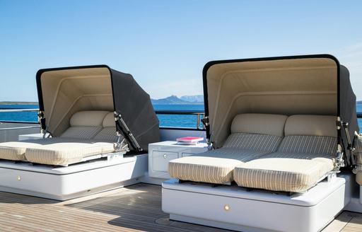 Sun loungers with covers onboard charter yacht STARFIRE