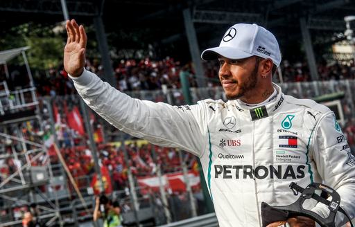 F1 driver Lewis Hamilton waves at crowds after F1 win