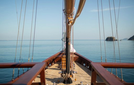 Overview of the bow onboard charter yacht VELA, with surrounding views of the sea.