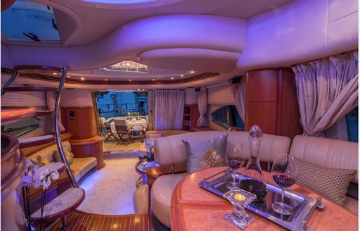 Main salon of M/Y ALMAZ, with blue lighting and seating areas