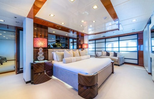 Overview of the master cabin with central berth and large windows onboard superyacht charter HOLDIN' MY OWN