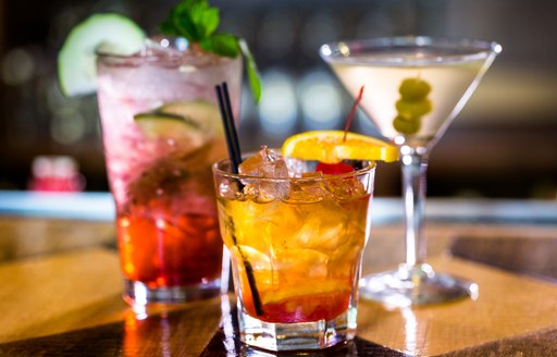 Selection of three colorful cocktails at a bar