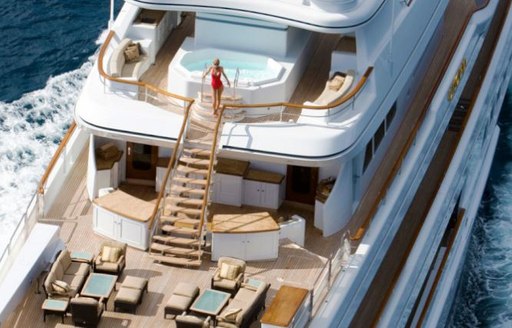 Aerial image of woman alighting steps on superyacht UTOPIA, which lead to aft deck seating