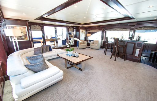 Main salon with L-shaped sofa and skylight aboard luxury yacht REBEL